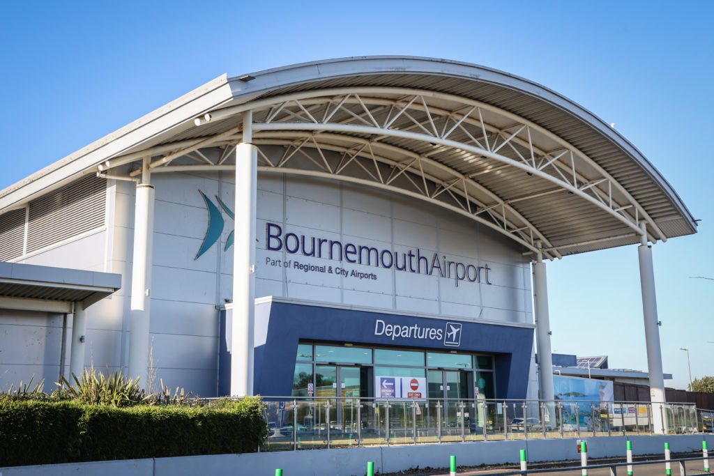 Bournemouth Airport passenger terminal exterior with airport signage and departures entrance